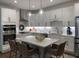 Bright and airy kitchen with island seating, stainless appliances, and white cabinetry at 63 Aspen Way, Dallas, GA 30157