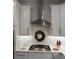 Stylish kitchen with white cabinets, subway tile backsplash, and stainless steel range hood at 63 Aspen Way, Dallas, GA 30157