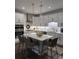 Bright, open kitchen featuring white cabinets, quartz counters, and a stylish island with seating at 63 Aspen Way, Dallas, GA 30157