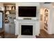 Living room features a fireplace, TV, and built-in shelving, ideal for relaxation and entertainment at 63 Aspen Way, Dallas, GA 30157