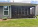 Relaxing screened-in patio has comfortable seating, a ceiling fan, and a view of the backyard at 63 Aspen Way, Dallas, GA 30157