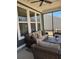 Relaxing screened patio with wicker furniture and a ceiling fan at 63 Aspen Way, Dallas, GA 30157