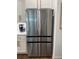 Close-up of a stainless steel refrigerator with white cabinets in the background at 63 Aspen Way, Dallas, GA 30157
