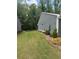Landscaped backyard features green lawn and mature trees at 63 Aspen Way, Dallas, GA 30157