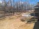 A view of the large backyard with a patio and staircase, set against a backdrop of lush trees at 6710 Grayland Dr, Douglasville, GA 30135