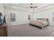 Bright primary bedroom boasts trey ceilings, plush carpeting, and dual windows offering ample natural light at 6710 Grayland Dr, Douglasville, GA 30135