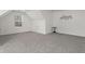 Large bonus room features gray carpet, a small door and a metal art piece at 6710 Grayland Dr, Douglasville, GA 30135