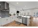 Open-concept kitchen with white cabinets, stainless appliances, and a view into the living room at 6710 Grayland Dr, Douglasville, GA 30135