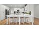 Bright kitchen featuring white cabinets, stainless appliances, large island with seating, and hardwood floors at 6710 Grayland Dr, Douglasville, GA 30135
