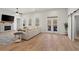 Spacious living room featuring hardwood floors, stone fireplace, and French doors that lead to the outside at 6710 Grayland Dr, Douglasville, GA 30135