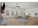 Bright living room with hardwood floors, large windows, ceiling fan, stone fireplace and sliding barn doors at 6710 Grayland Dr, Douglasville, GA 30135