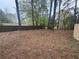 A fenced backyard with sparse groundcover and mature trees at 3488 Richmond Se Dr, Conyers, GA 30094