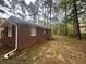 Side view of a brick home showing the landscaped backyard at 3488 Richmond Se Dr, Conyers, GA 30094