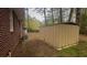 A brick home and storage shed are situated in the grassy backyard at 3488 Richmond Se Dr, Conyers, GA 30094