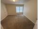 Cozy bedroom featuring neutral walls, soft carpeting, and a bright window at 3839 Henry Ct, Acworth, GA 30101