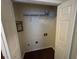 Functional closet space with storage shelving and electrical outlets for laundry appliances at 3839 Henry Ct, Acworth, GA 30101
