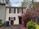 Charming two-story townhouse with neutral siding, dark shutters, and a well-maintained front yard at 3839 Henry Ct, Acworth, GA 30101