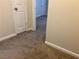 Hallway featuring neutral carpet flooring, clean trim, and easy access to other rooms at 3839 Henry Ct, Acworth, GA 30101