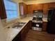 Well-lit kitchen featuring stainless steel appliances, wood cabinetry, and stone countertops at 3839 Henry Ct, Acworth, GA 30101