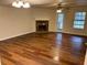 Cozy living room featuring a fireplace, hardwood floors, and natural light from a nearby window at 3839 Henry Ct, Acworth, GA 30101