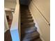 Carpeted staircase featuring a white handrail and a glimpse of the living room at 3839 Henry Ct, Acworth, GA 30101