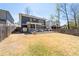 Large, grassy backyard with patio, screened porch, and ample space for outdoor activities at 4064 Comanche Dr, Tucker, GA 30084