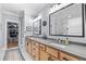 A sleek bathroom with double vanity, modern fixtures, and a large mirror at 4064 Comanche Dr, Tucker, GA 30084