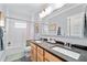 Modern bathroom with double sinks, a large mirror, and a shower-tub combination at 4064 Comanche Dr, Tucker, GA 30084
