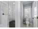 Modern bathroom showcases glass shower with black and white tile at 4064 Comanche Dr, Tucker, GA 30084