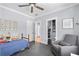 Cozy bedroom features a ceiling fan, closet, and a comfortable reading chair at 4064 Comanche Dr, Tucker, GA 30084