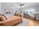 A bright bedroom with hardwood floors, a ceiling fan, and a large window for ample natural light at 4064 Comanche Dr, Tucker, GA 30084