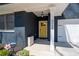 Inviting front entrance with yellow door, covered porch, and elegant architectural details at 4064 Comanche Dr, Tucker, GA 30084