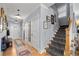 Open hallway with hardwood floors, staircase, and stylish decor, creating a welcoming atmosphere at 4064 Comanche Dr, Tucker, GA 30084