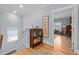 Charming hallway features hardwood floors, a glass cabinet, and an open doorway to another room at 4064 Comanche Dr, Tucker, GA 30084