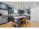Modern kitchen features an island with bar stools, and stainless steel appliances at 4064 Comanche Dr, Tucker, GA 30084