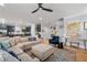Bright living room with an area rug, a large sofa, and a ceiling fan at 4064 Comanche Dr, Tucker, GA 30084