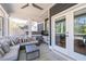 Covered porch provides an outdoor living area with comfortable seating and a ceiling fan at 4064 Comanche Dr, Tucker, GA 30084
