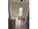 Bathroom with tiled tub, tile surround, natural light and wood-look flooring at 5760 Old Carriage Dr, Atlanta, GA 30349