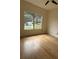 Vaulted bedroom with ceiling fan, natural light from window, and wood-look flooring at 5760 Old Carriage Dr, Atlanta, GA 30349