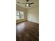 A cozy bedroom with hardwood floors, a ceiling fan, and natural light, creating a warm and inviting atmosphere at 5760 Old Carriage Dr, Atlanta, GA 30349