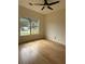 Bedroom featuring ceiling fan, natural light from window, and wood-look flooring at 5760 Old Carriage Dr, Atlanta, GA 30349