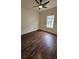 Bedroom featuring wood flooring, a ceiling fan, and a window for natural light that creates a relaxing retreat at 5760 Old Carriage Dr, Atlanta, GA 30349