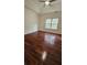 Bright bedroom featuring hardwood floors, a ceiling fan, and natural light from a window at 5760 Old Carriage Dr, Atlanta, GA 30349