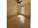 Bright bedroom with ceiling fan, natural light from window, and wood-look flooring at 5760 Old Carriage Dr, Atlanta, GA 30349