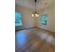 Dining Room featuring wood floors, natural light from windows, and modern lighting fixture at 5760 Old Carriage Dr, Atlanta, GA 30349