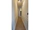 Hallway with wainscoting detail and tile flooring, seamlessly connects the home's living spaces at 5760 Old Carriage Dr, Atlanta, GA 30349