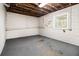 Unfinished basement with painted block walls, a window, and concrete floor offers customization opportunities at , Decatur, GA 30035