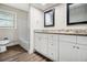 Updated bathroom featuring dual sinks, granite countertops, and wood look floors at , Decatur, GA 30035