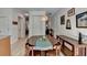 Spacious dining area with a wooden table, decorative wall paneling, and hardwood flooring at 1213 Harris Commons Place, Roswell, GA 30076