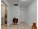 Bright hallway with hardwood floors, table, and white walls leading to various rooms at 1213 Harris Commons Place, Roswell, GA 30076